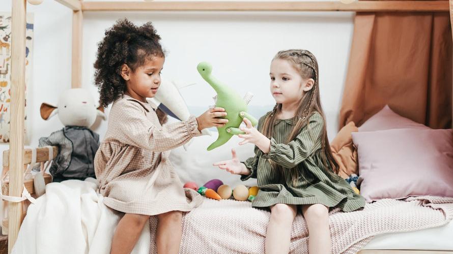 Two little girls playing dinosaur