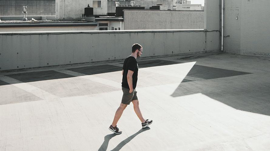 man walking across roof for exercise
