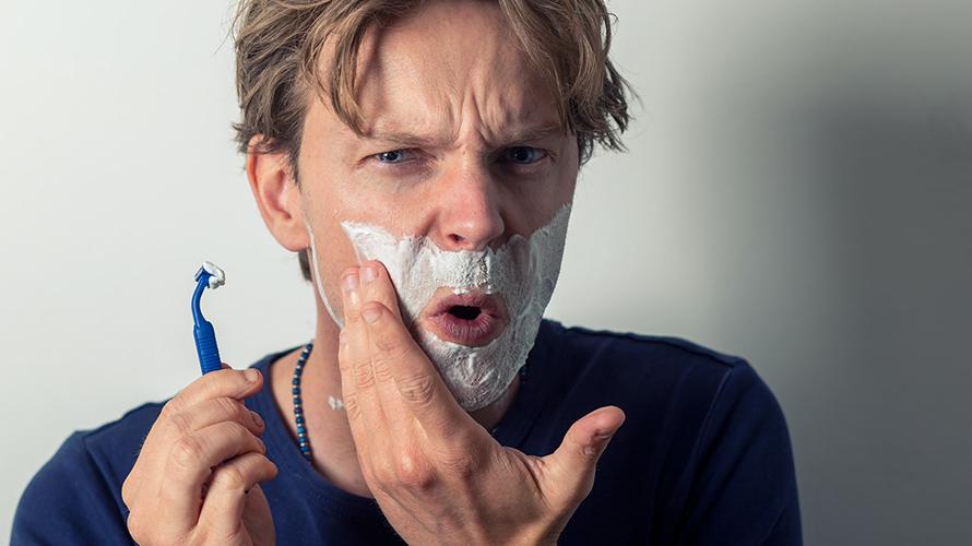 Man in pain while shaving