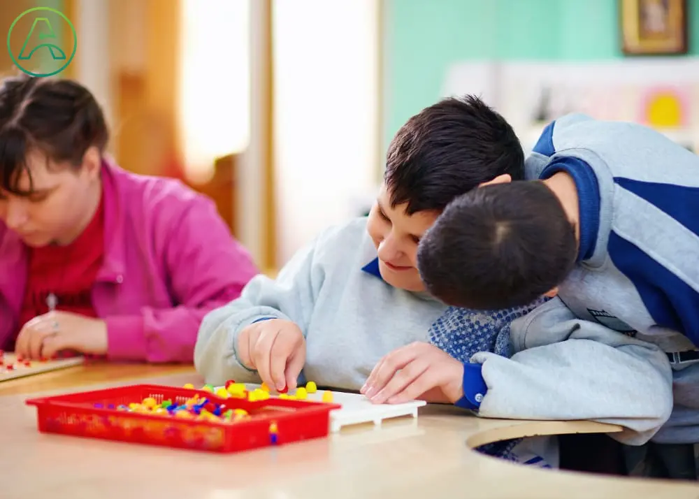 Three adolescents with Cerebral Palsy participate in classroom activities.