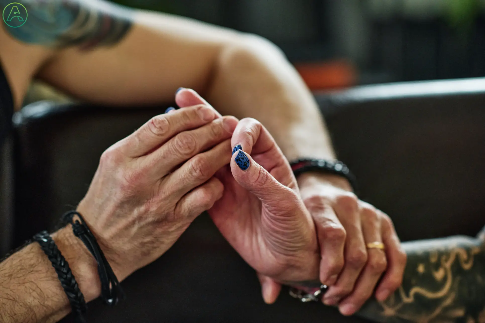 A man and woman use tactile signing to communicate.