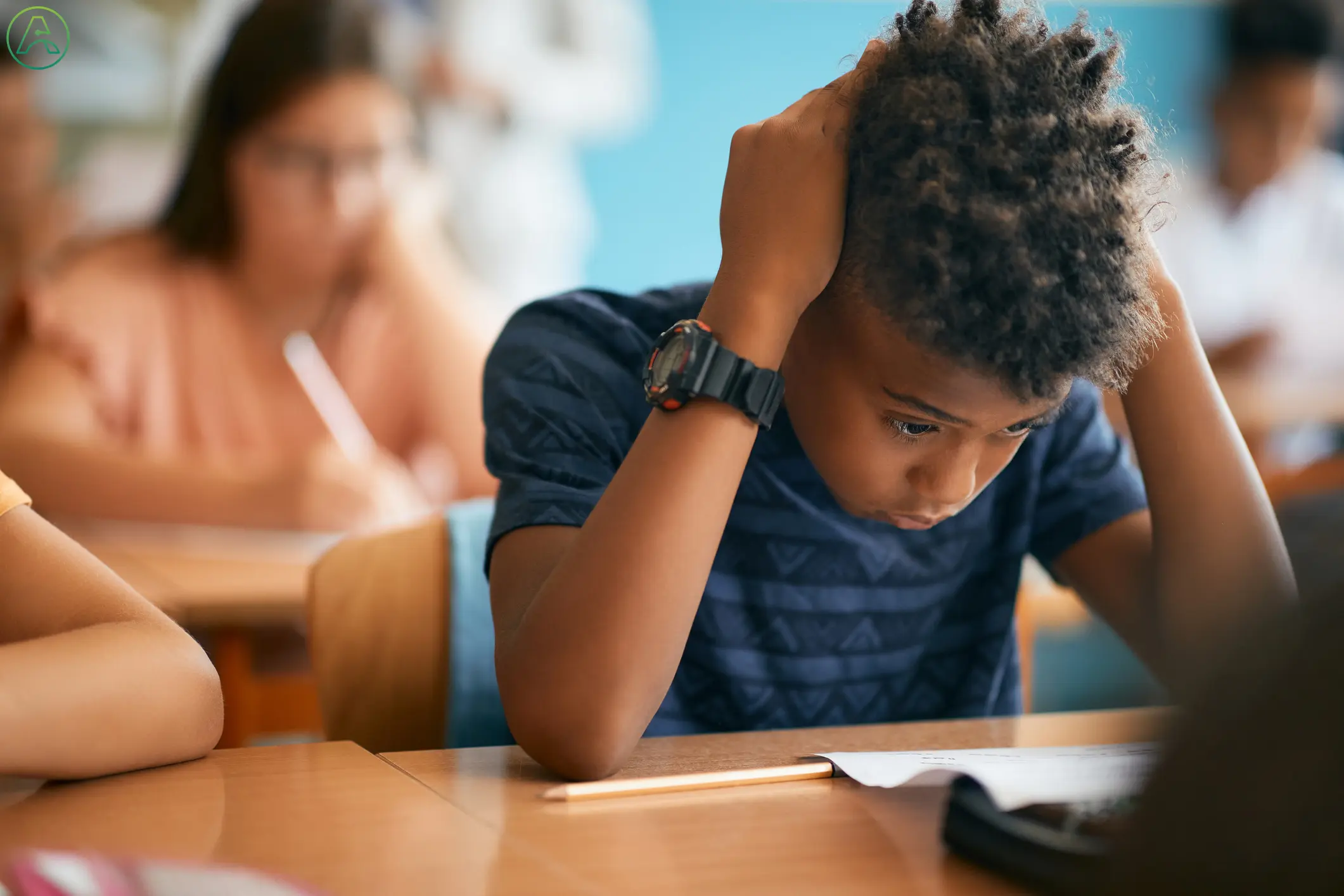 An anxious boy with dark skin, curly hair, and a blue striped shirt holds his head in both hands while struggling to make sense of a math test.