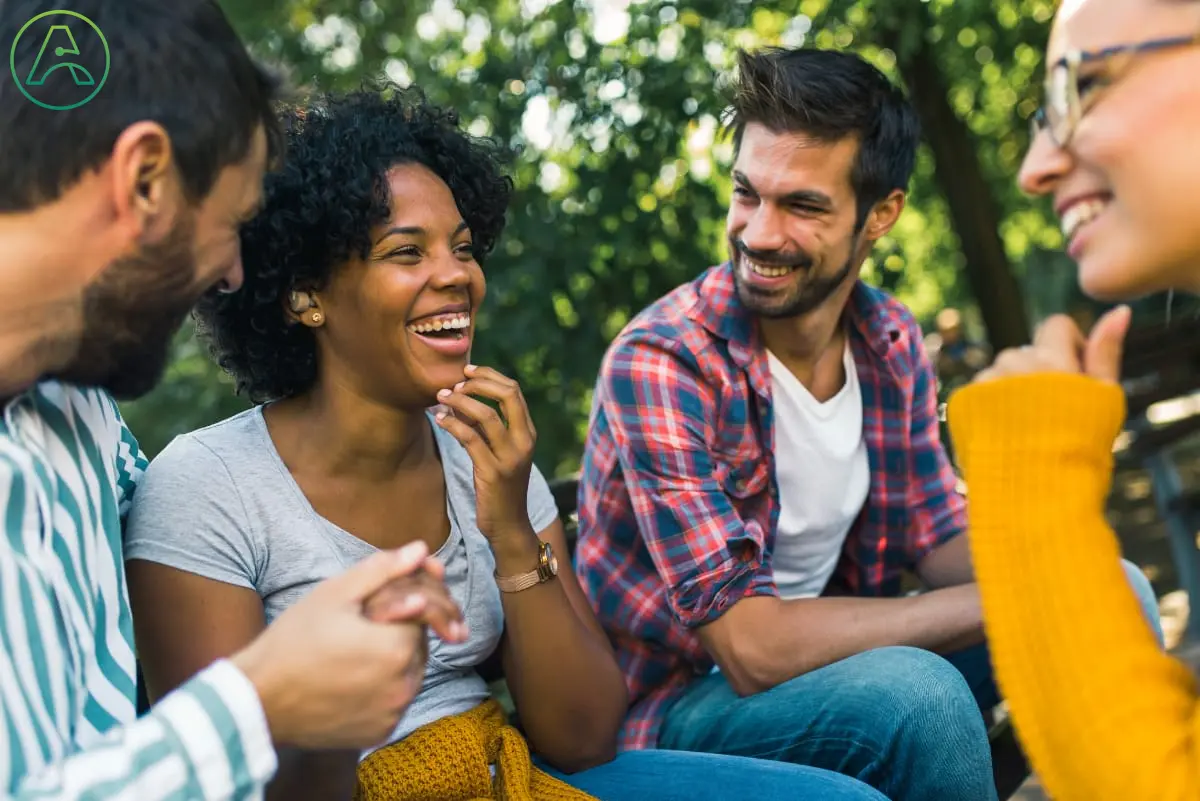 A diverse group communicates using sign language.