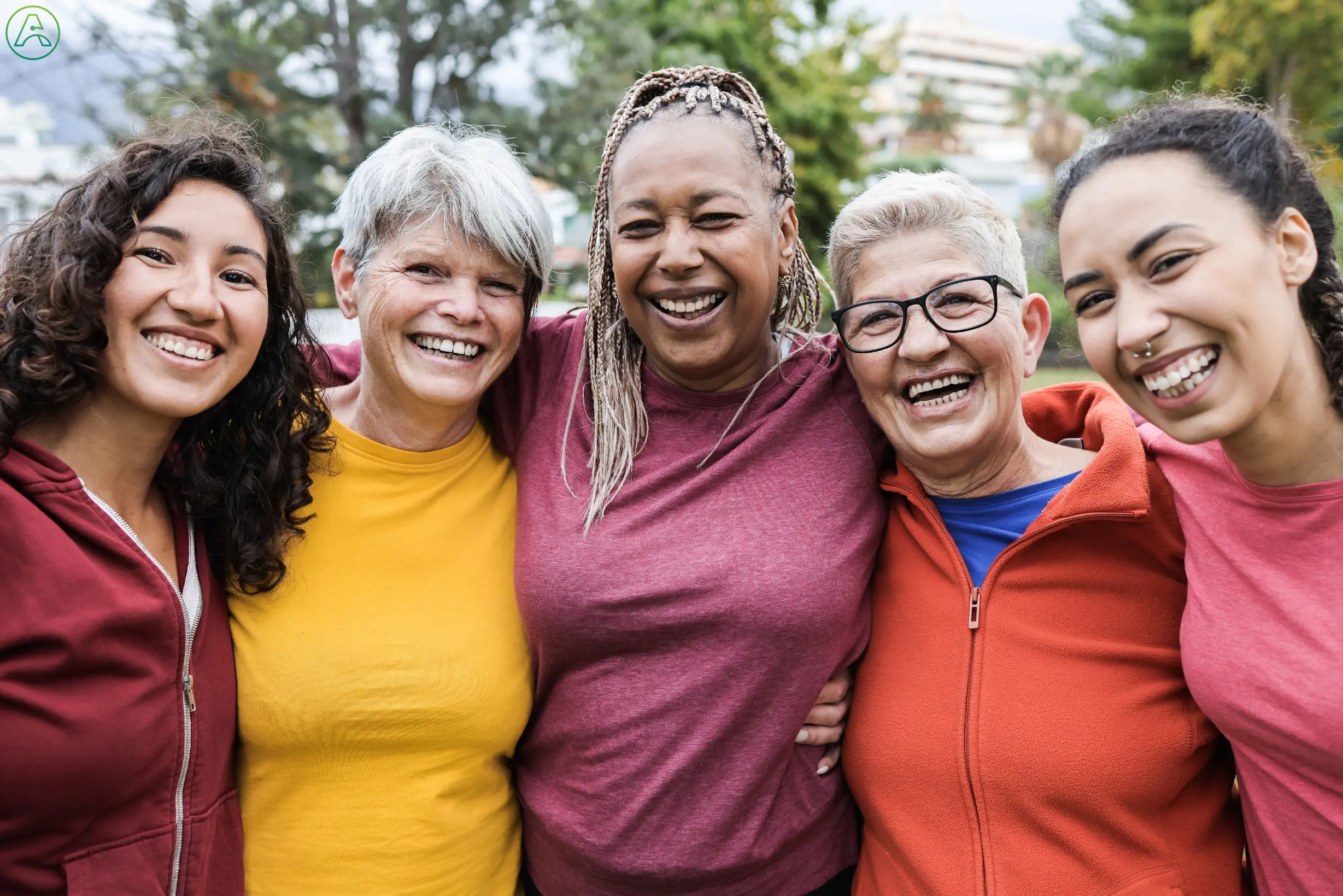 Diverse group of women after an exercise class outdoors.