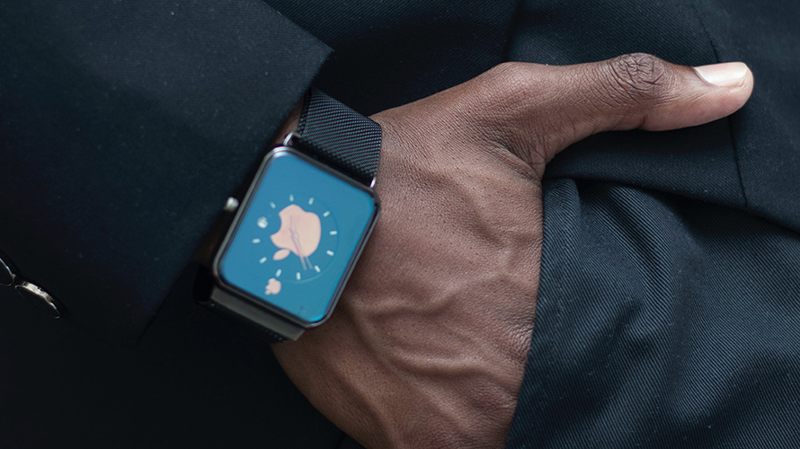 Man's hand in suit pocket with an Apple watch