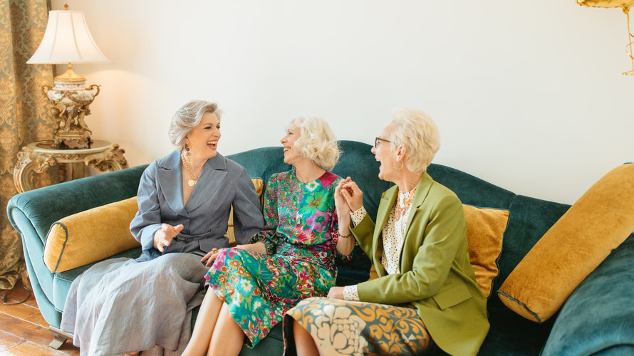 The older women on couch laughing together